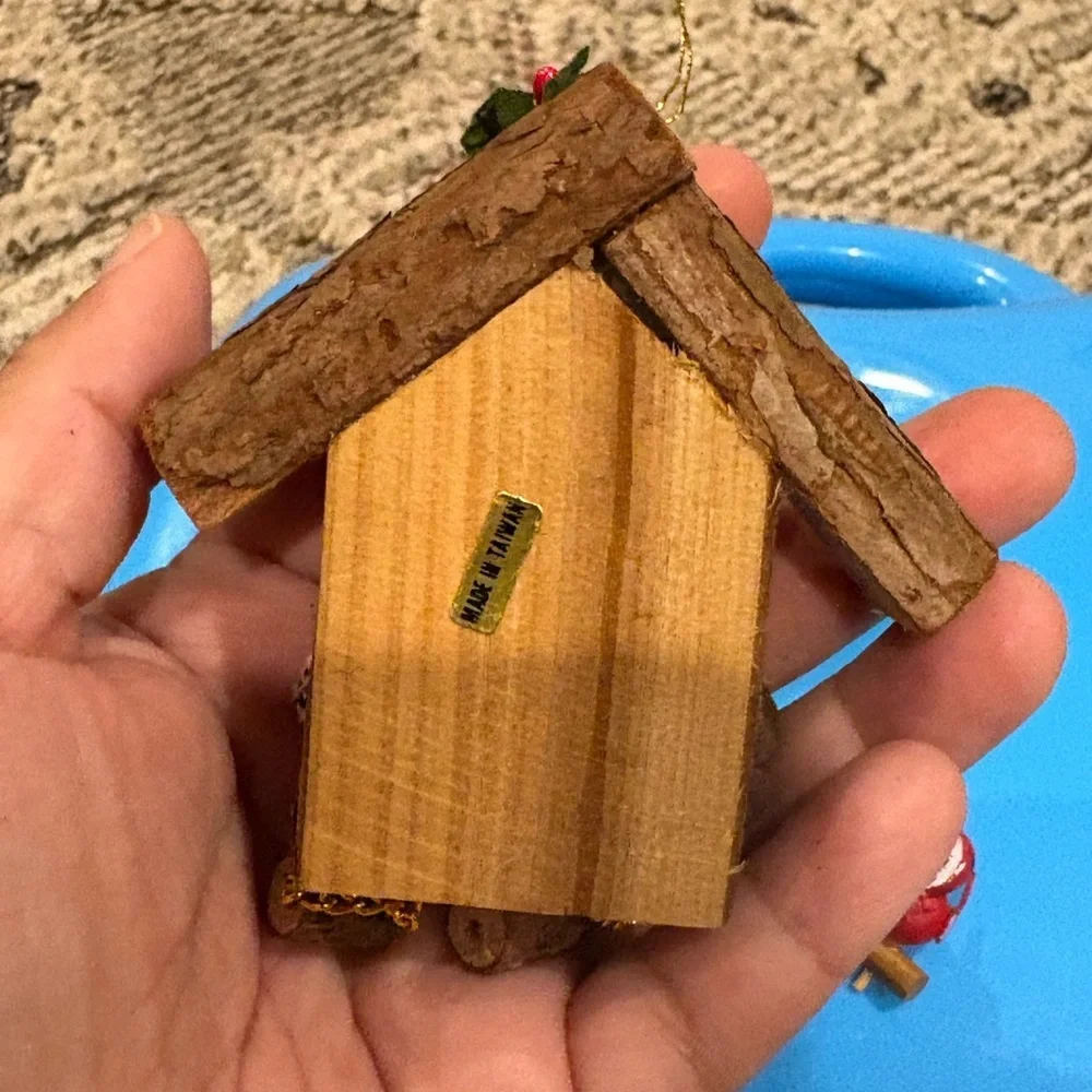 Christmas ornament depicting a wooden bird house clock